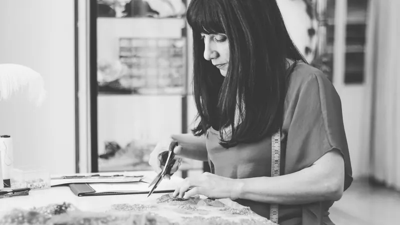 Fabric and lace being worked on a wedding gown in the Catherine Colubriale atelier
