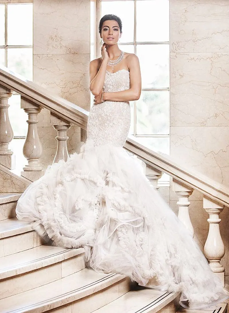 A bride in her bespoke Catherine Colubriale gown on a sandstone staircase