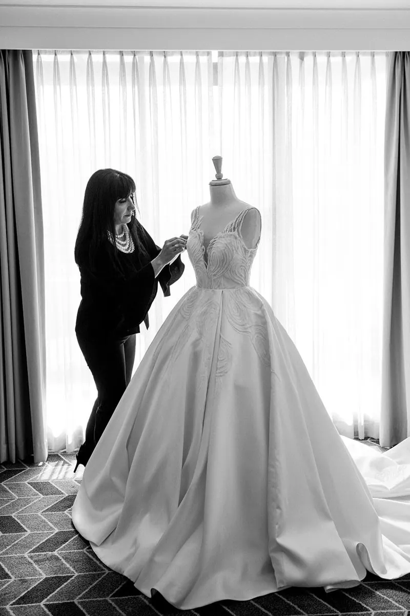 A couture gown being fitted on the stand in the atelier